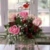 
This elegant arrangement, featuring vibrant pink roses paired with rich red Peruvian