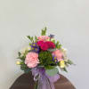 White alstroemeria, green dianthus, hot pink spray roses, yellow mini carnations in