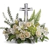 This peaceful bouquet of soft white flowers and green accents is a