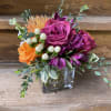 Low Arrangement in a Clear Glass Cube of jewel tone roses, pin