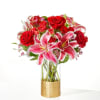 Blooming red roses, exquisite lilies, and accents of spray roses are expertly