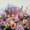 A bouquet pastel mix of lavender and pink flowers arranged in a
