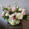 A classic spring garden-style arrangement featuring roses, astilbe and tulips in shades