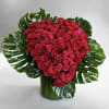 This vase arrangement is overflowing with red Roses in the shape of