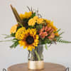 Brighten any space instantly with this radiant sunflower arrangement paired with soft