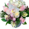 Soft pinks and creams in a cylinder vase, flower varieties used based