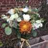 Seasonal chrysanthemums, eucalyptus, stock and fresh white wildflowers offer a lightly fragrant