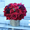 Red Roses and burgundy Chrysanthemums with accents of red Tulips in an