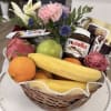 A beautifully arranged gourmet basket filled with fresh tropical fruits and premium