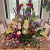 red ginger, pink roses, green anthurium, purple orchids, proteas, tropical leaves, liatris