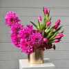 Modern floral arrangement featuring vibrant pink dahlias and fresh pink tulips, artfully
