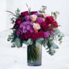 Devotion in Bloom is a richly expressive arrangement created to honor love
