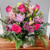 This Arrangement has Beautiful Hot pink roses blush pink lillies. Mixed with