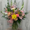 A clear vase with a nice mix of some beautiful flowers to