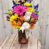 colored mason jar filled with bright fresh flowers