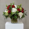 Red roses, white hydrangea, mini green hydrangea with assorted greenery in a