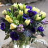 A spring like vase filled with tulips and Hyacinths in creamy and