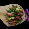 A beautiful collection of colorful tulips presented as loose wrap bouquet (