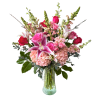 A soft, glowing arrangement of roses, lilies, hydrangea and seasonal greenery. 