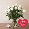 A dozen premium extra long white roses, beautifully accented with lush greens
