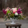 An elegant all around design in a classy pedestal container. The footed