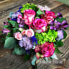 This exclusive bouquet features a gathering of blooms in bright, cheerful colors