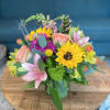 This mixed bouquet is set in a glass vase with an assortment