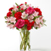 Blushing shades of pink blooms are nestled in lush greens to charm