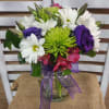 Hot pink alstroemerias, lime green fugis and vibrant purple lisianthus pop against