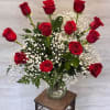 A classic arrangement of vibrant red roses accented with delicate baby&rsquo;s breath