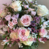 Designer&rsquo;s Choice cut flowers in pastel colors, arranged in a hand tied