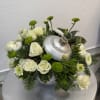 A festive arrangement of seasonal blooms and winter greenery, designed to bring