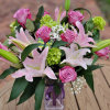 This dramatic arrangement includes stunning roses, lilies &amp; mini hydrangeas with the