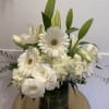 A graceful arrangement of white gerbera, white lilies, and delicate lisianthus, designed