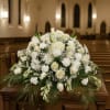 fresh mix flowers in casket setting 