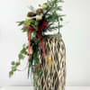 Large willow lantern with fresh and artificial decor. Battery operated candle included.