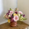 A whimsical summer blooms arrangement with gerber daisies, stock, snapdragon, astilbe, and