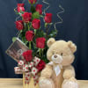 This modern, one-sided arrangement includes a dozen red roses, a cute cuddle