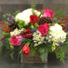 Lush arrangement of hydrangea, roses, tuips, cones and winterberry