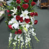 Red rose, white asiatic lilies and cascading orchids hand crafted to create