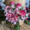 Mixed arrangement of Roses, Carnations, and Alstroemeria. In shades of Pink, Red