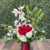 This modern style arrangement designed 3 sided consists of orchids, roses, hydrangeas