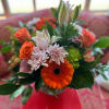 Pink lilies, orange roses, gerbera, green hydrangea, pink alstromeria and lavender cushion