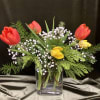 Perfect pick me up arrangement of bright tulips and greenery, colors may