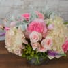 Soft blush and pink flowers Gather to a perfect arrangement  