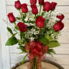 A classic dozen roses in a vase.  