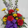 Mix of carnations, larkspur and vibrate yellow viking daisies make this a