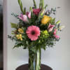 Mix of season flowers with lush florals which may include roses, spray