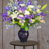 Purple Iris, Blue Delphinium, White roses and Chrysanthemums create a stunning display.