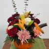 Lilies, roses, and mums hold all the ambiance of fall, family and